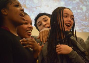 Students singing on stage in the Student Union.