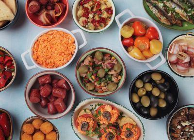 An overhead view of many small food dishes.